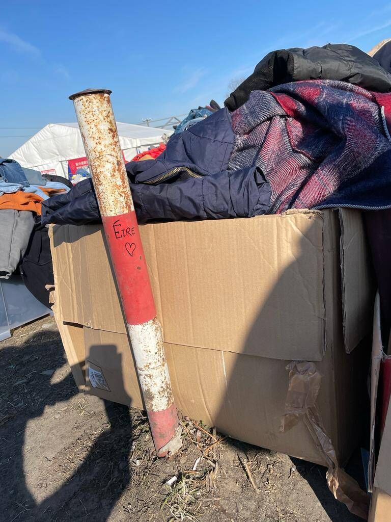 The word Éire can be seen written on a pole next to stacks and stacks of clothes discarded at Medyka border crossing The word Éire can be seen written on a pole next to stacks and stacks of clothes discarded at Medyka border crossing