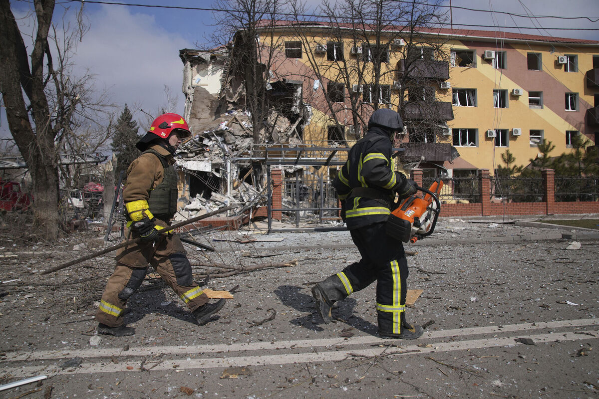 Firefighters walk past a damaged by shelling building in Mariupol. Picture: AP Photo/Evgeniy Maloletka Firefighters walk past a damaged by shelling building in Mariupol. Picture: AP Photo/Evgeniy Maloletka