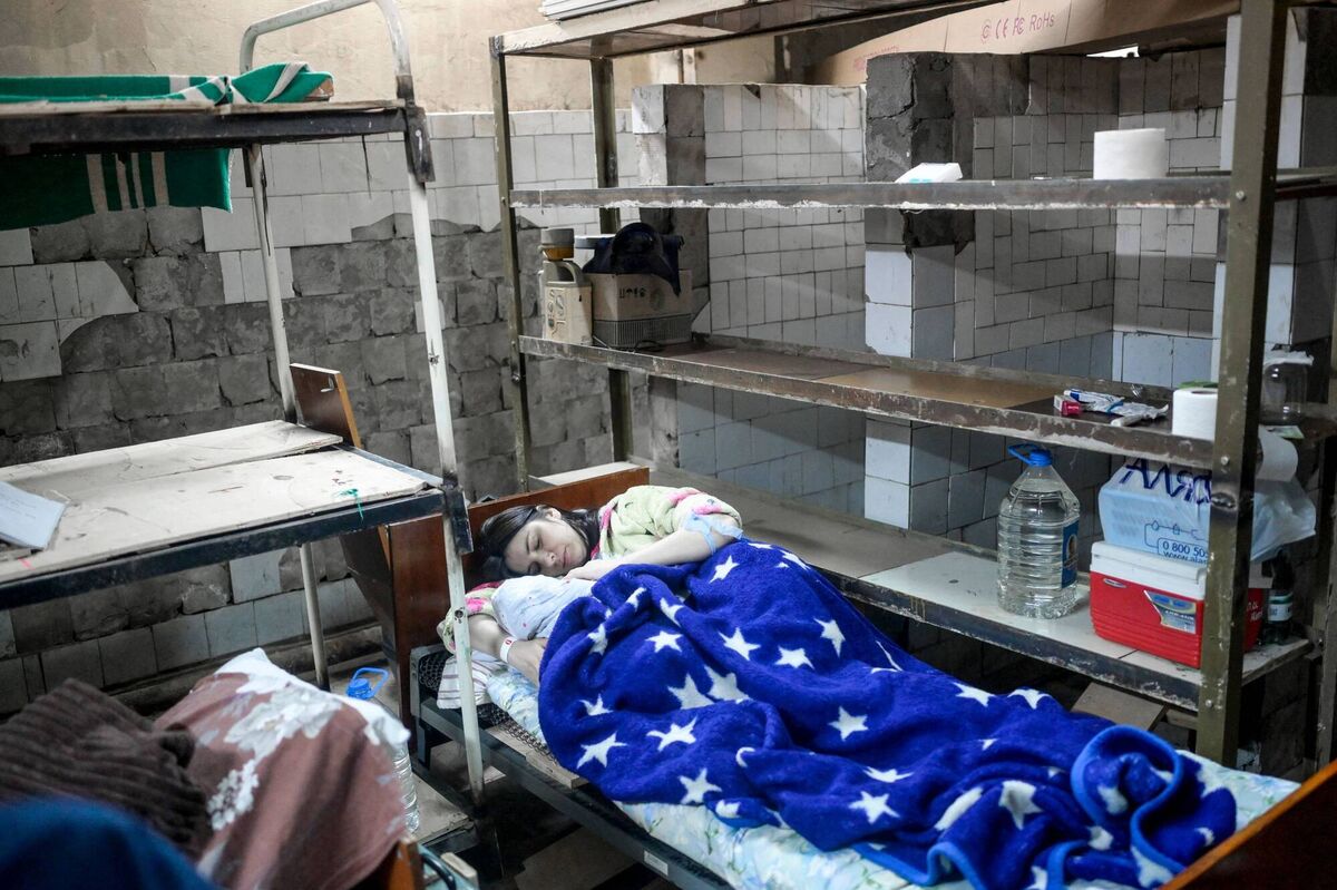 A woman lies in the basement of a maternity hospital shortly after giving birth to her baby as sirens warn of air raids in Mykolaiv on Monday. Almost half of the 49 women have had to give birth in the basement since 24 February. Photo: Bulent Kilic / AFP via Getty Images
