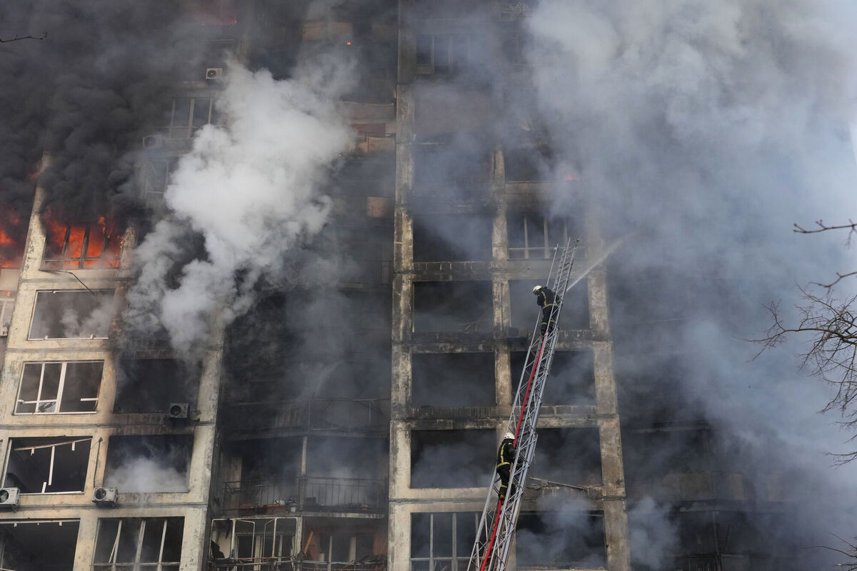 Firefighters work in an apartment building damaged by shelling in Kyiv. AP Photo/Efrem Lukatsky)