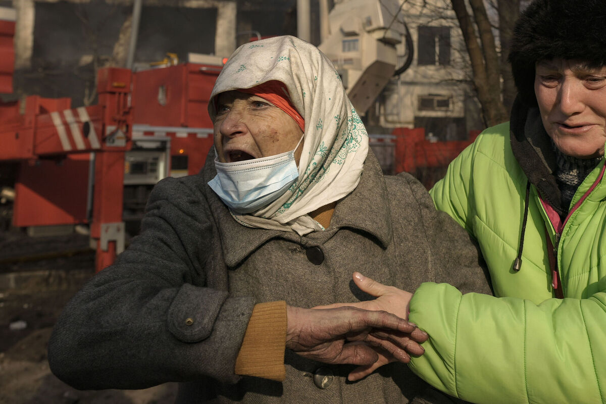 Women cry outside a destroyed apartment building after a bombing in a residential area in Kyiv. Picture: AP Photo/Vadim Ghirda