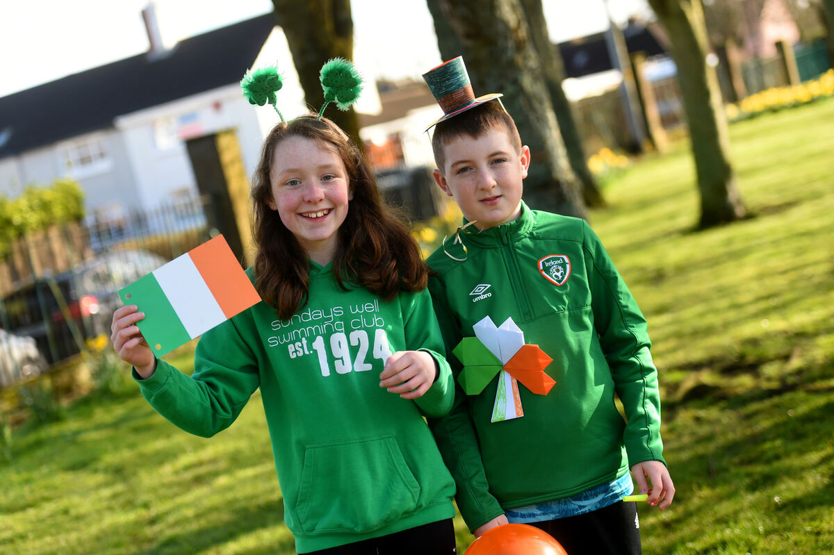  Coisins Aoife Mannix and Gearóid Ó Mhurchú from Ranga 5 of Gaelscoil An Teaghlaigh Naofa taking part in the school parade on Wednesday. Picture: Larry Cummins.