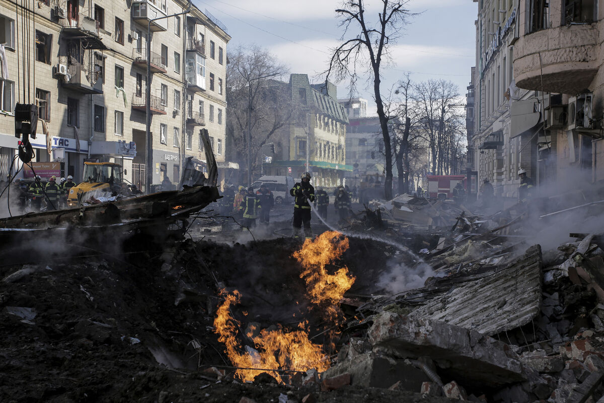 Firefighters extinguish flames outside an apartment house after a Russian rocket attack in Kharkiv. Picture: AP Photo/Pavel Dorogoy