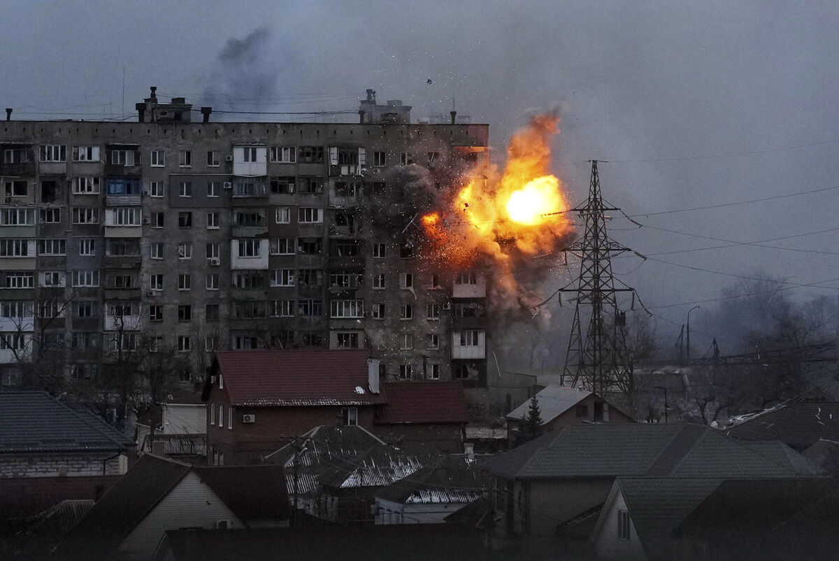 An apartment building explodes after a Russian army tank fires in Mariupol, Ukraine, March 11, 2022. (AP Photo/Evgeniy Maloletka)