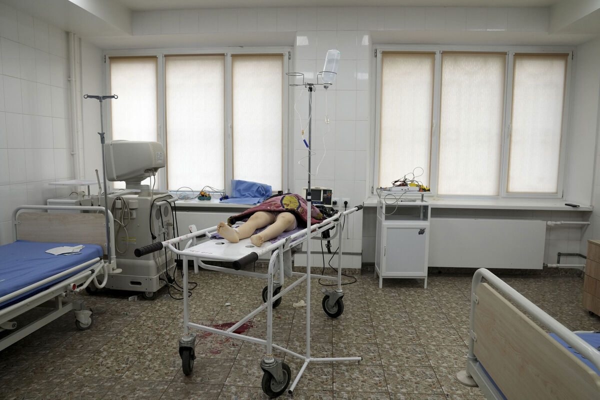 The lifeless body of a girl killed during shelling at a residential area lies on a medical cart at the city hospital of Mariupol, eastern Ukraine, Sunday, Feb. 27, 2022. (AP Photo/Evgeniy Maloletka)