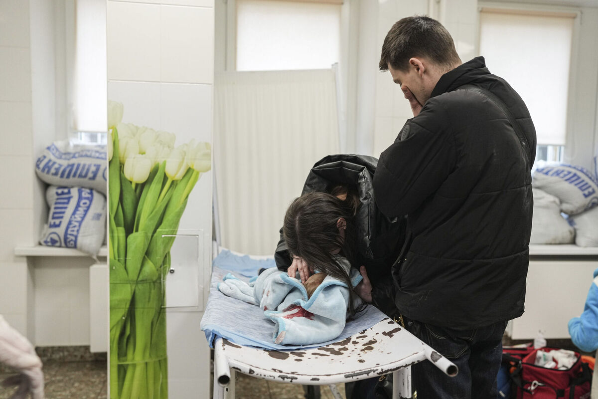 Marina Yatsko, left, and her boyfriend Fedor mourn over her 18 month-old son Kirill's lifeless body, killed in shelling, as he lays on a stretcher in a hospital in Mariupol, Ukraine, Friday, March 4, 2022. (AP Photo/Evgeniy Maloletka)