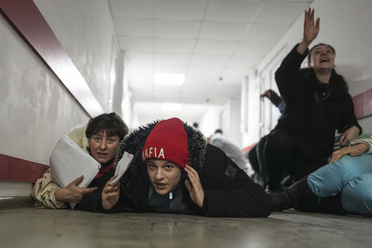People lie on the floor of a hospital during shelling by Russian forces in Mariupol, Ukraine, March 4, 2022. (AP Photo/Evgeniy Maloletka)