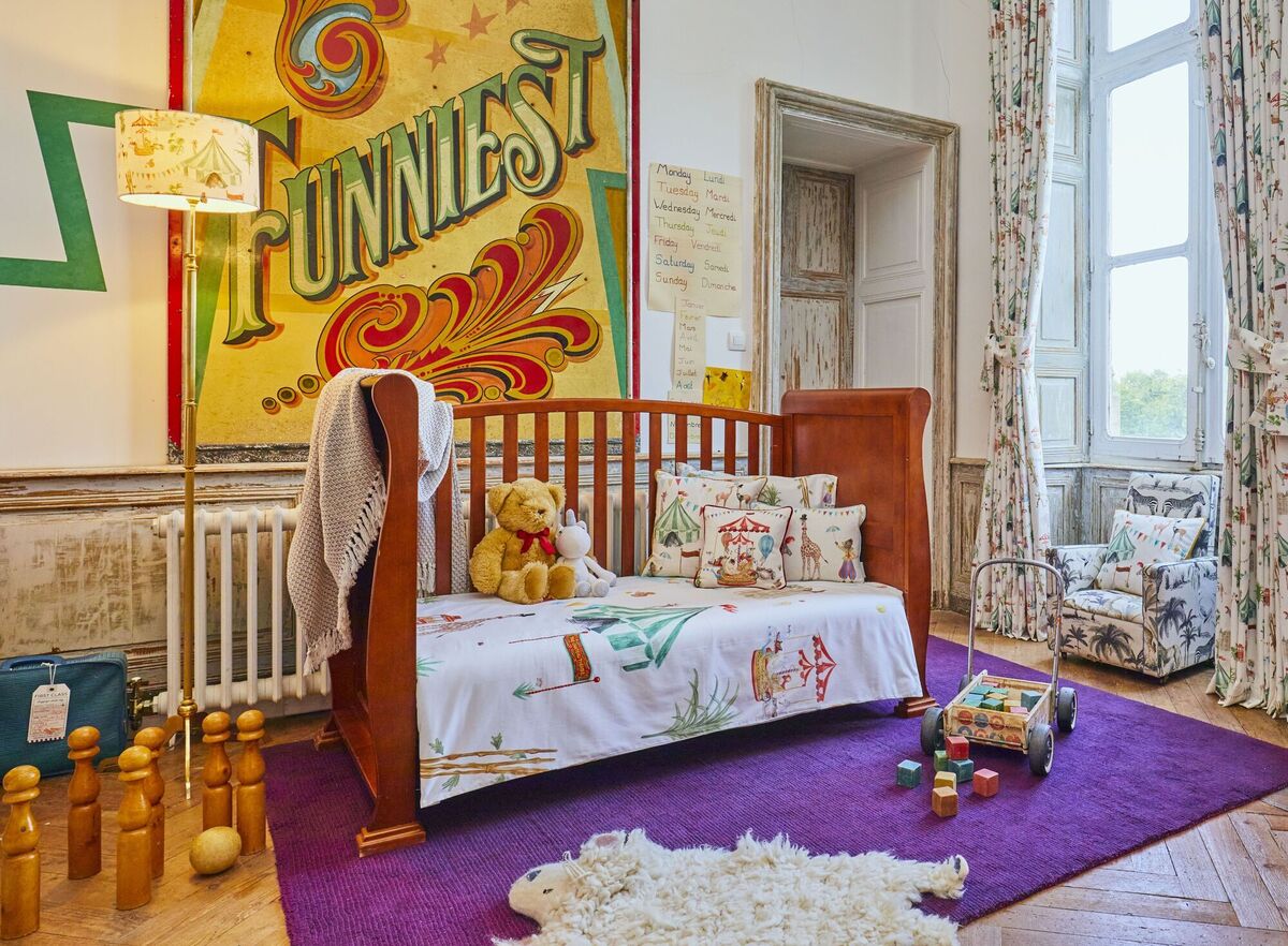  An enchanting children's bedroom in the chateau has been designed by Angel with floral printed textiles inspired by the locale and French circus themes.