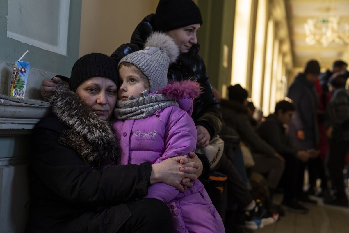 Ukrainian refugee Elena, left, hugs her five-year old granddaughter Christina, as they wait the train to Warsaw, at the Przemysl train station, southeastern Poland. Picture: AP Photo/Petros Giannakouris Ukrainian refugee Elena, left, hugs her five-year old granddaughter Christina, as they wait the train to Warsaw, at the Przemysl train station, southeastern Poland. Picture: AP Photo/Petros Giannakouris