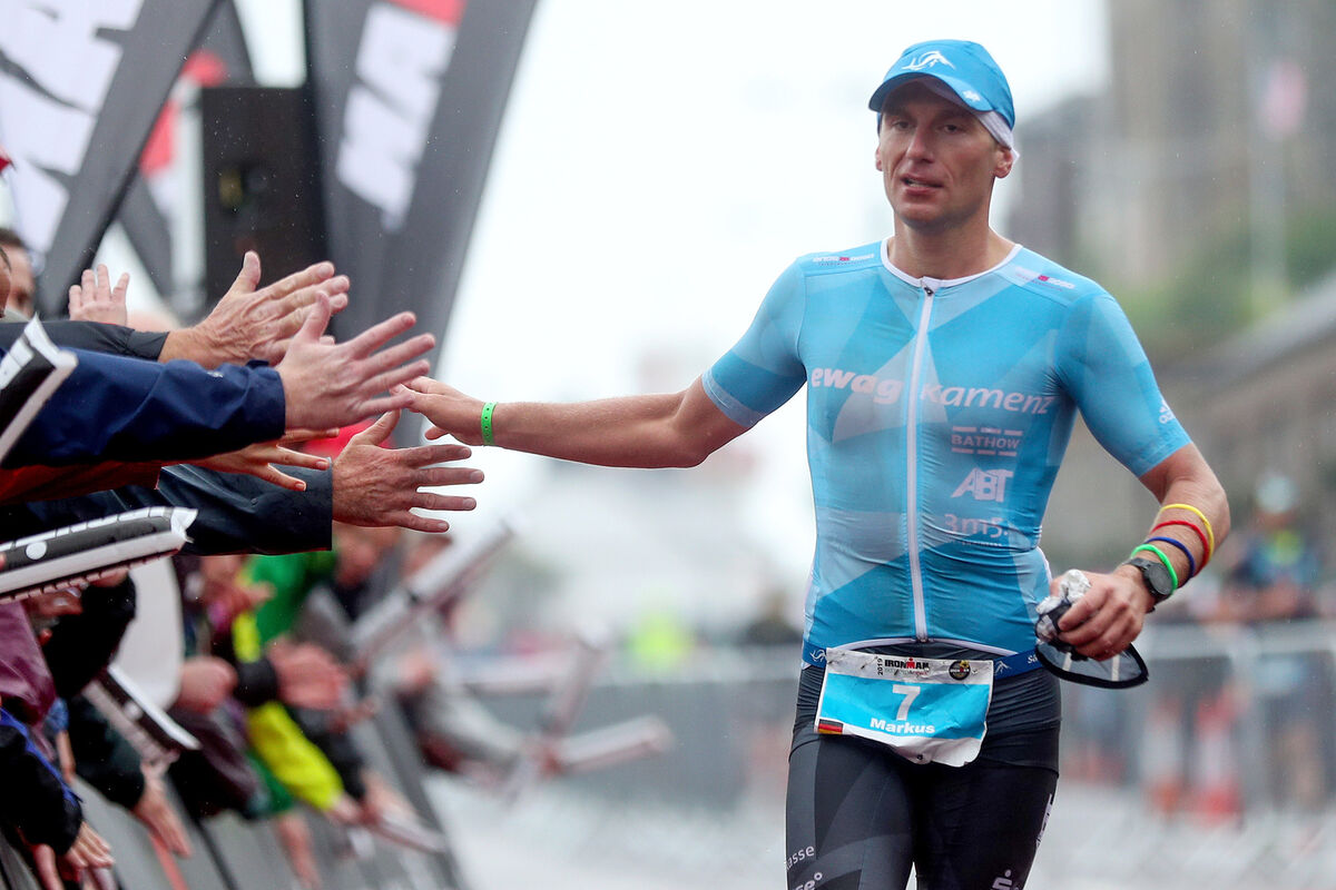 Markus Thomschke celebrates as he crosses the line in third place at the 2019 Ironman.