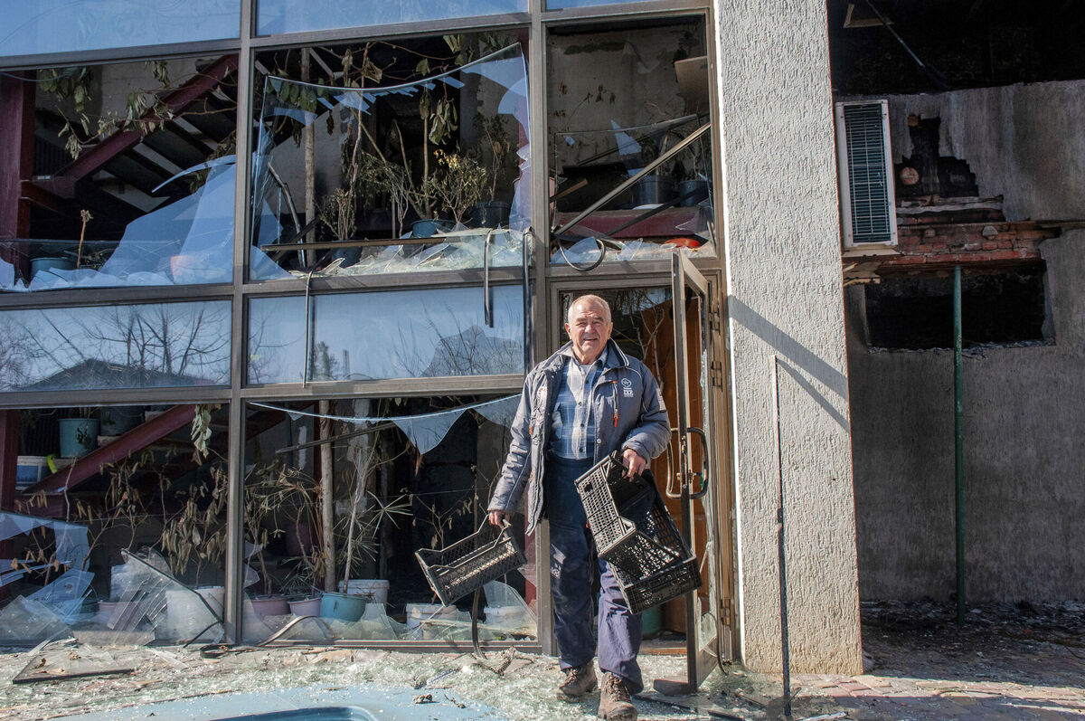 A man walks next to an apartments building hit by shelling in Kharkiv, Ukraine, Sunday, March 20, 2022. (AP Photo/Andrew Marienko) A man walks next to an apartments building hit by shelling in Kharkiv, Ukraine, Sunday, March 20, 2022. (AP Photo/Andrew Marienko)
