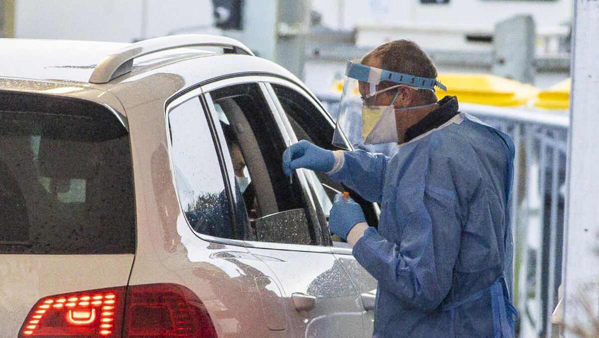 A worker at the Dundalk Stadium Covid-19 drive-through test centre prepares to give a PCR test. A worker at the Dundalk Stadium Covid-19 drive-through test centre prepares to give a PCR test.