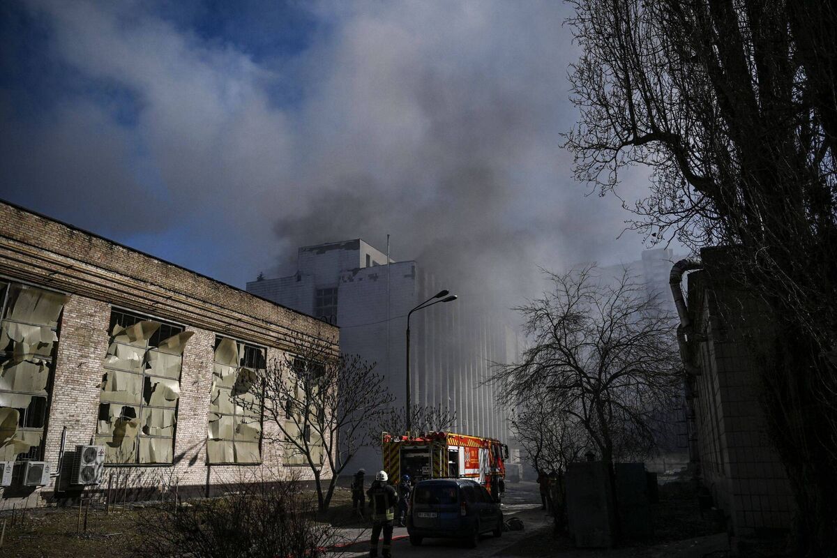 Firefighters are seen as smoke billows from a building of a research institute, part of Ukraine's National Academy of Science, after a strike in northwestern Kyiv, on March 22, 2022. Picture: Aris Messinis / AFP (Photo by ARIS MESSINIS/AFP via Getty Images)