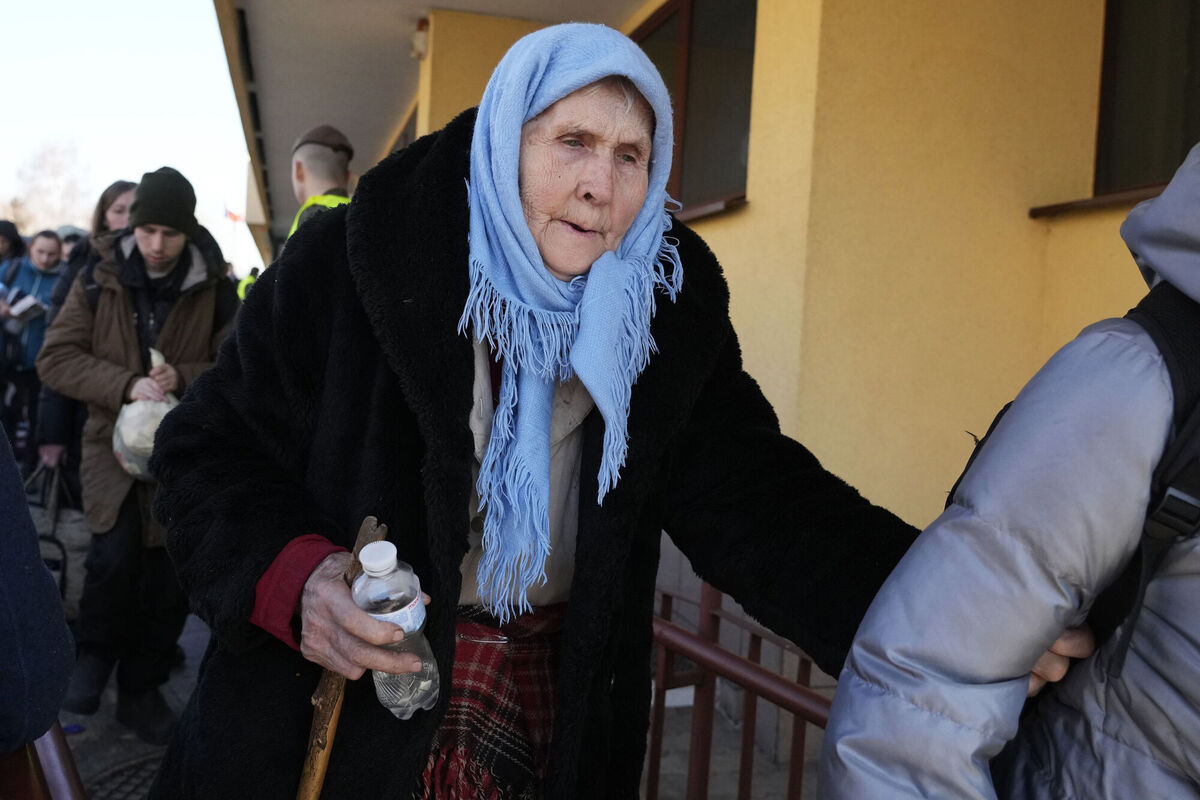 An elderly woman walks at a railway station in Przemysl, Poland, after fleeing the war from neighbouring Ukraine, on Tuesday, March 22, 2022. Picture: AP Photo/Sergei Grits