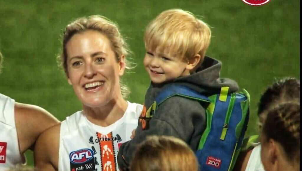 Family singalong: Bríd Stack is joined by her son Ógie on the pitch after the last match of the season against Geelong. 