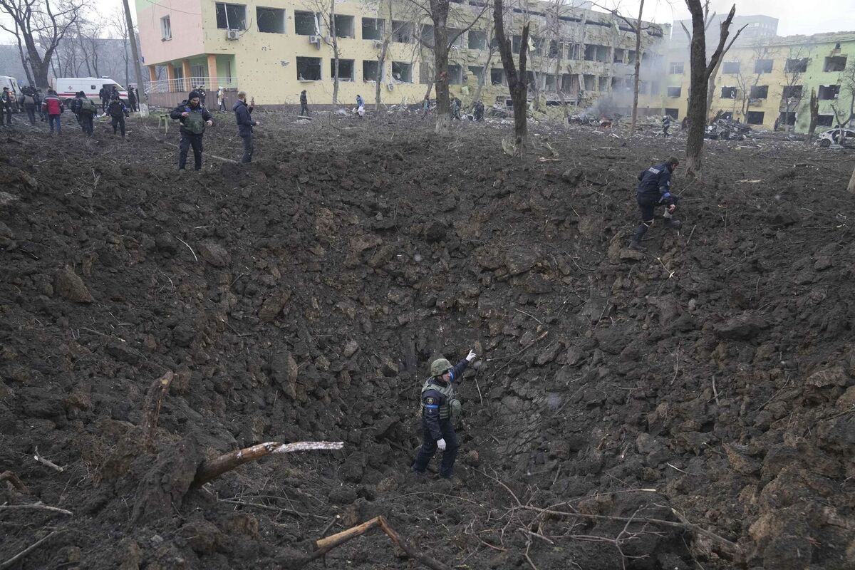Ukrainian soldiers and emergency employees work at the side of the damaged by shelling maternity hospital in Mariupol, Ukraine. Picture: AP Photo/Evgeniy Maloletka