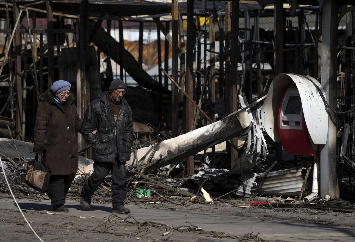 People walk past destroyed buildings as civilians being evacuated along humanitarian corridors from the Ukrainian city of Mariupol under the control of Russian military and pro-Russian separatists. Picture: Stringer/Anadolu Agency via Getty Images