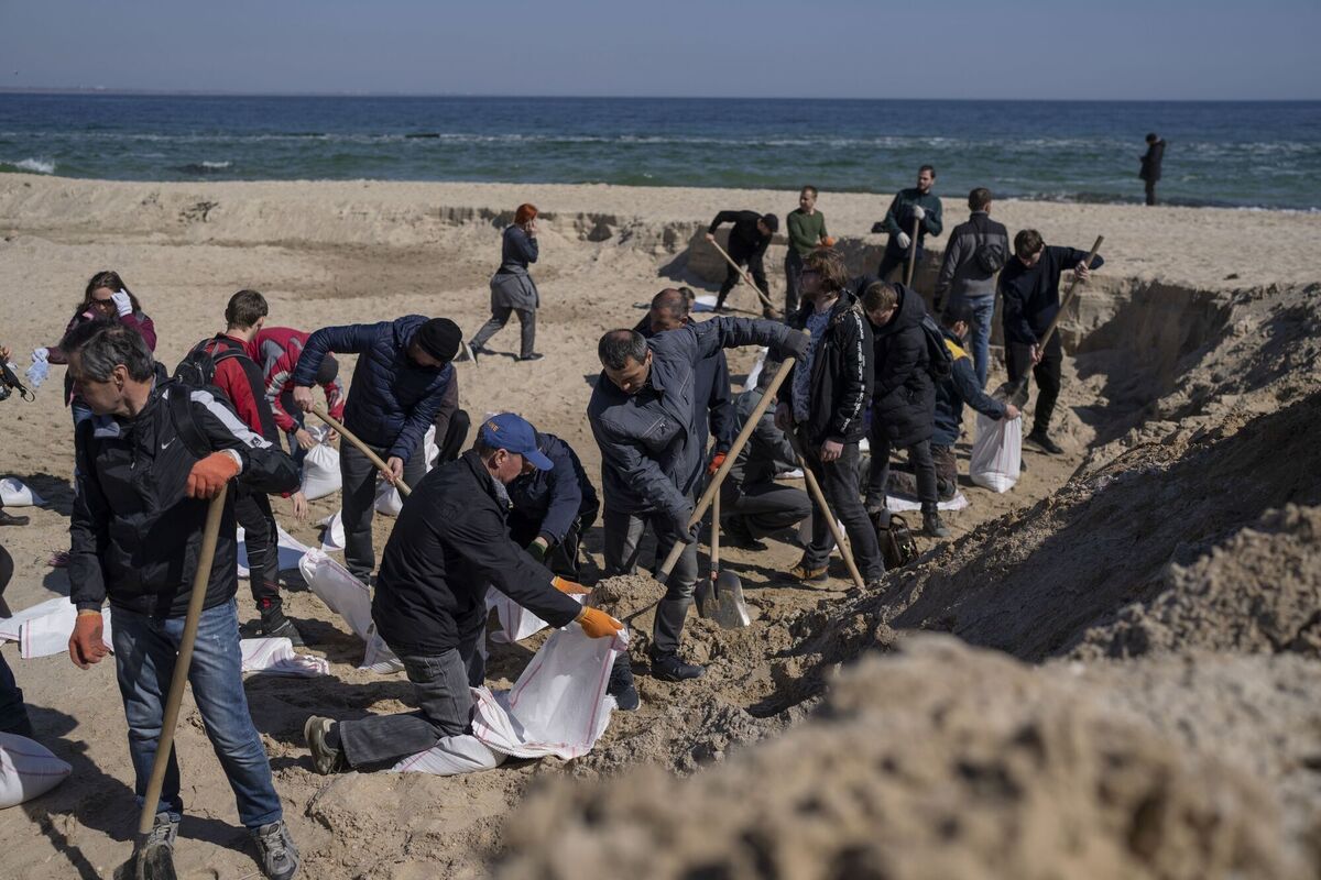 Volunteers at a sand beach fill sandbags to defend their city, in Odesa, southern Ukraine. Picture: AP Photo/Petros Giannakouris