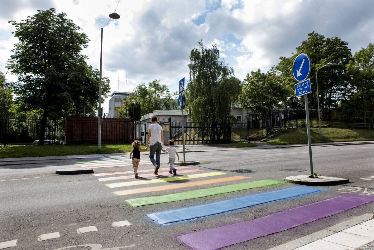 A mother and her children walk across the zebra crossing outside of the Russian embassy in Stockholm; gay rights supporters painted the crossing in the colours of the rainbow over the Russia's treatment of LGBT individuals. Picture: Getty 