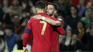 <p>Portugal's Bruno Fernandes celebrates with Cristiano Ronaldo, left, after scoring his side's second goal during the World Cup 2022 playoff soccer match between Portugal and North Macedonia, at the Dragao stadium in Porto, Portugal, Tuesday, March 29, 2022. (AP Photo/Luis Vieira)</p>