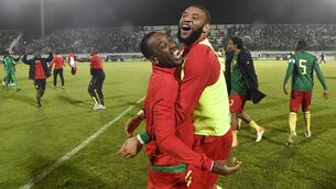 <p>Cameroon's players celebrate after qualifying for the 2022 Qatar World Cup in Qatar following their match with Algeria at the Mustapha Tchaker Stadium in the city of Blida on March 29, 2022. (Photo by AFP) (Photo by -/AFP via Getty Images)</p>