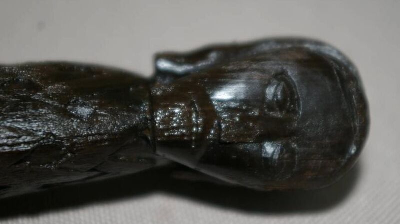 The carved head on the weaver's sword. The carved head on the weaver's sword.