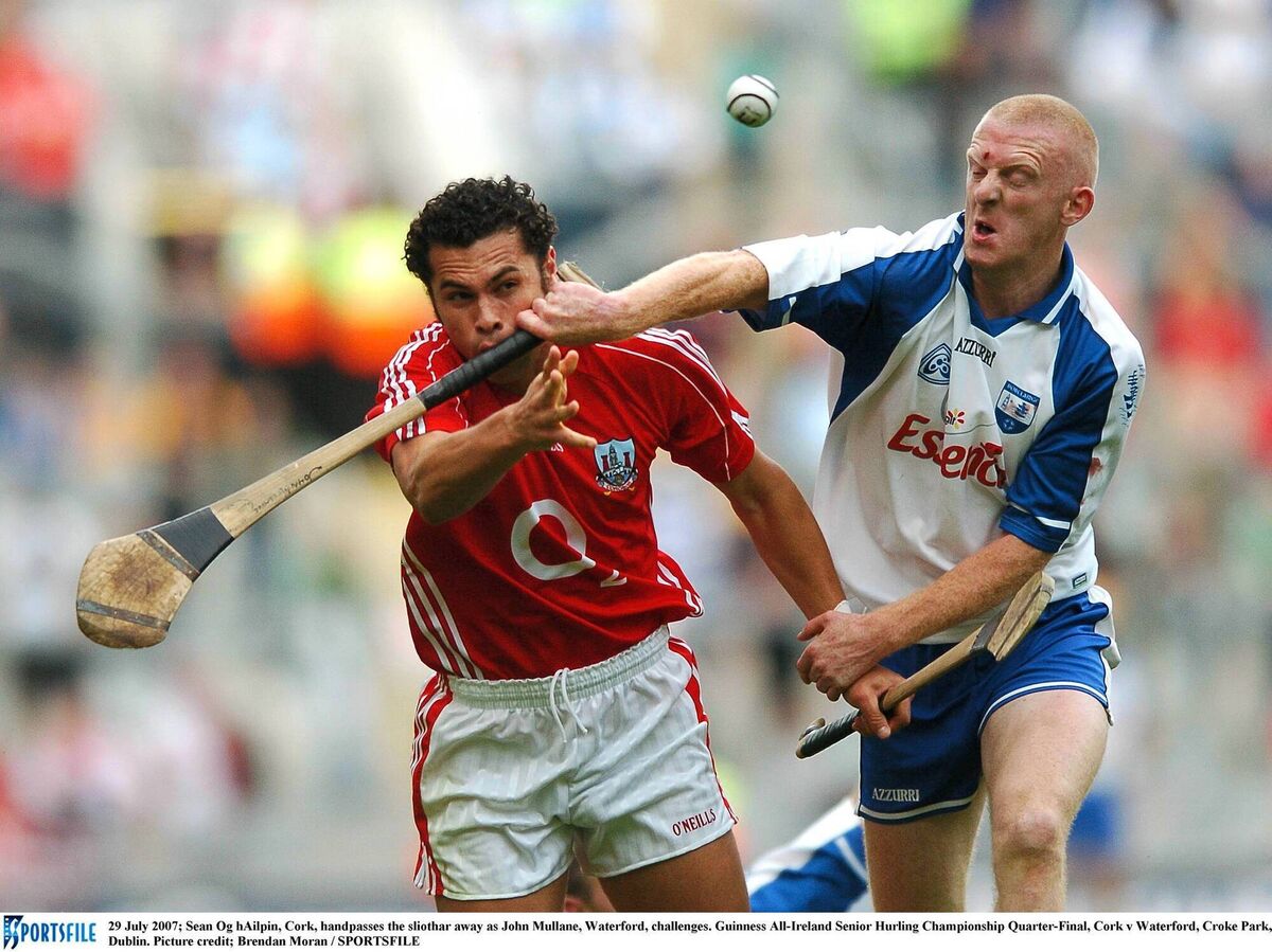 Seán Óg hAilpín handpasses the sliothar away as Waterford's John Mullane challenges for possesion in the 2007 All-Ireland SHC quarter-final in Croke Park. Picture: Brendan Moran / SPORTSFILE