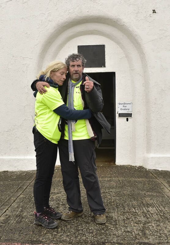 Charlie and his wife Claire took a moment together after completing the tough climb. Picture: Conor McKeown