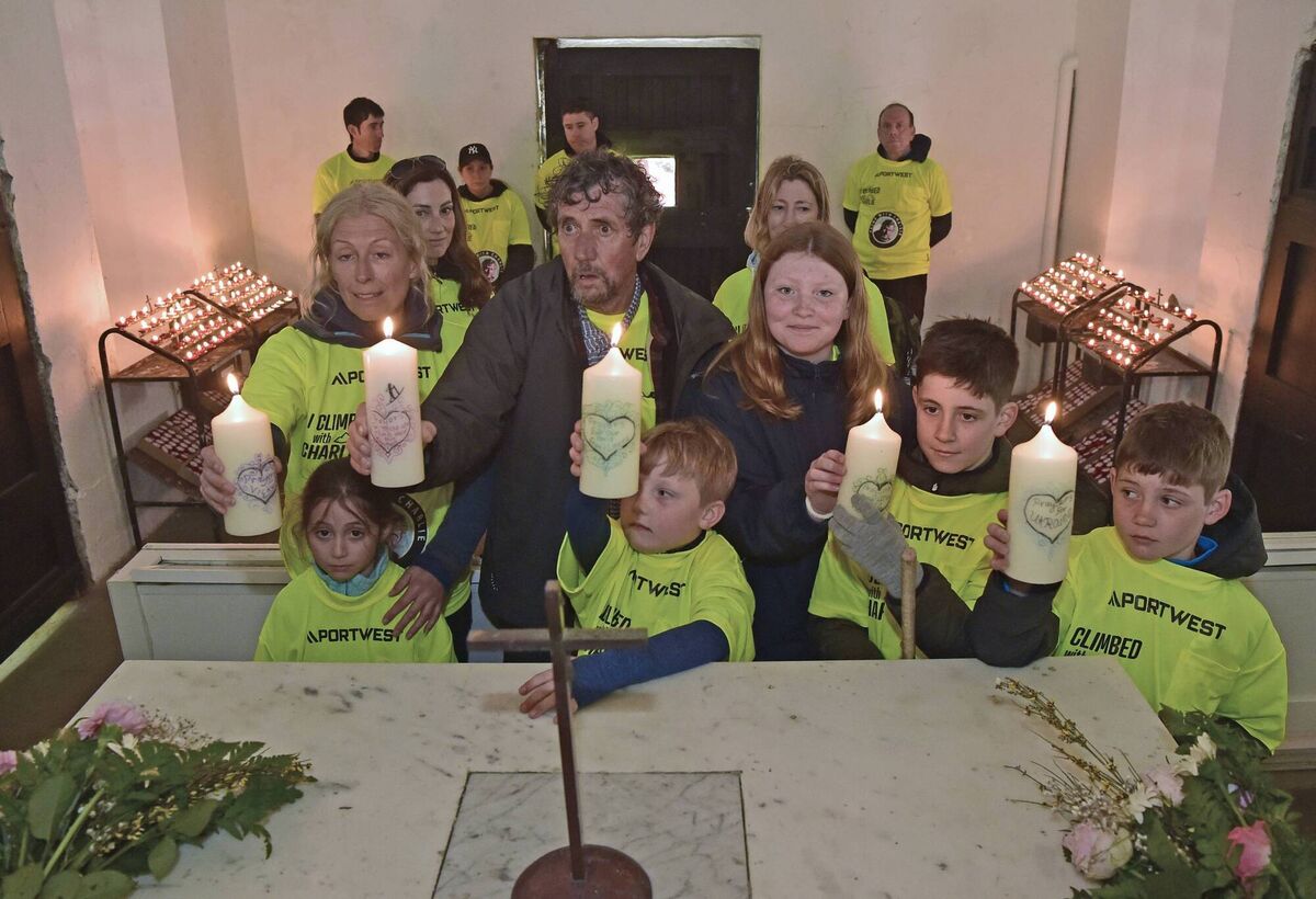 Claire Mould and Charlie Bird with his grandkids after they lit five candles in the church on the summit of Croagh Patrick. Picture: Conor McKeown Claire Mould and Charlie Bird with his grandkids after they lit five candles in the church on the summit of Croagh Patrick. Picture: Conor McKeown
