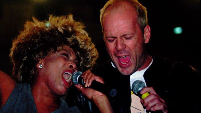 US singer Tina Turner and actor Bruce Willis sing together during a rehearsal at Bercy stadium in Paris, on May 3, 1996. Willis and his group The Accelerators are the opening act for Turner's Wildest Dreams world tour. Picture: Michel Euler/AP