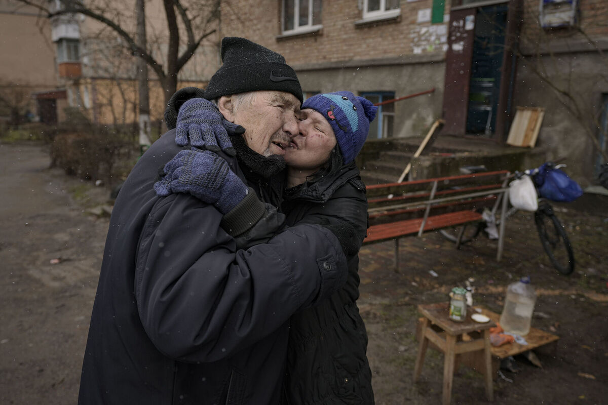 A woman kisses a man while cooking on an open fire outside an apartment building which had no electricity, water or gas since the beginning of the Russian invasion in Bucha, Ukraine, Sunday, April 3, 2022. Picture: AP Photo/Vadim Ghirda A woman kisses a man while cooking on an open fire outside an apartment building which had no electricity, water or gas since the beginning of the Russian invasion in Bucha, Ukraine, Sunday, April 3, 2022. Picture: AP Photo/Vadim Ghirda