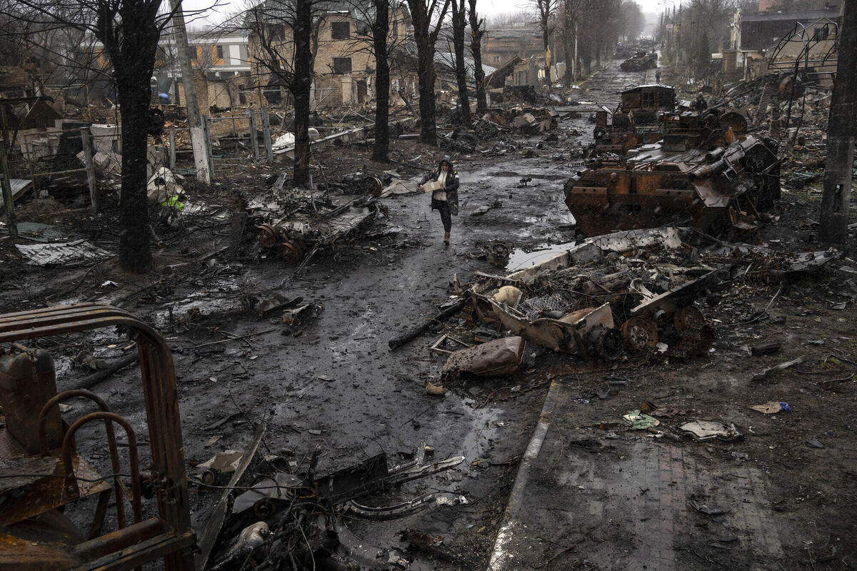 A woman walks amid destroyed Russian tanks in Bucha, in the outskirts of Kyiv, Ukraine, Sunday, April 3, 2022. Picture: AP Photo/Rodrigo Abd A woman walks amid destroyed Russian tanks in Bucha, in the outskirts of Kyiv, Ukraine, Sunday, April 3, 2022. Picture: AP Photo/Rodrigo Abd