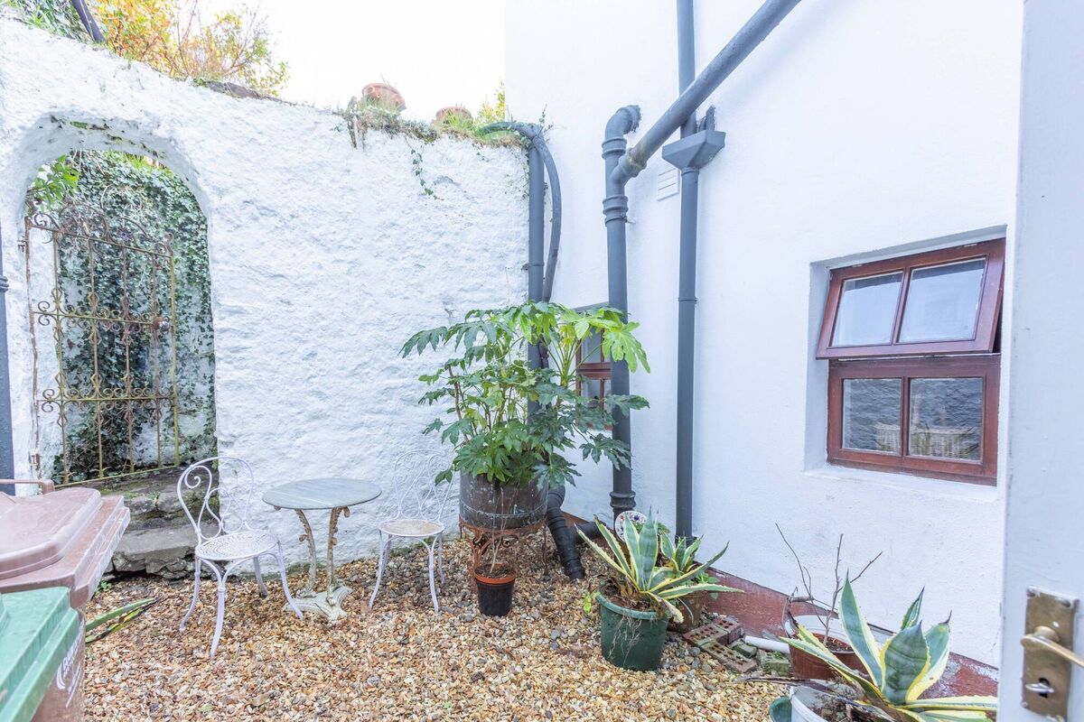 Courtyard links No 2 to a rear garden further beyond