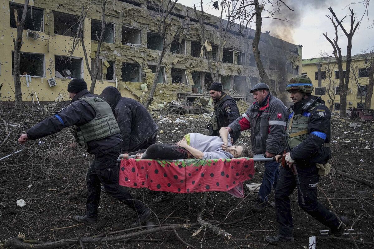Ukrainian emergency employees and volunteers carry an injured pregnant woman from a maternity hospital that was damaged by shelling in Mariupol, Ukraine, March 9, 2022. The woman and her baby died after Russia bombed the maternity hospital where she was meant to give birth. (AP Photo/Evgeniy Maloletka, File)
