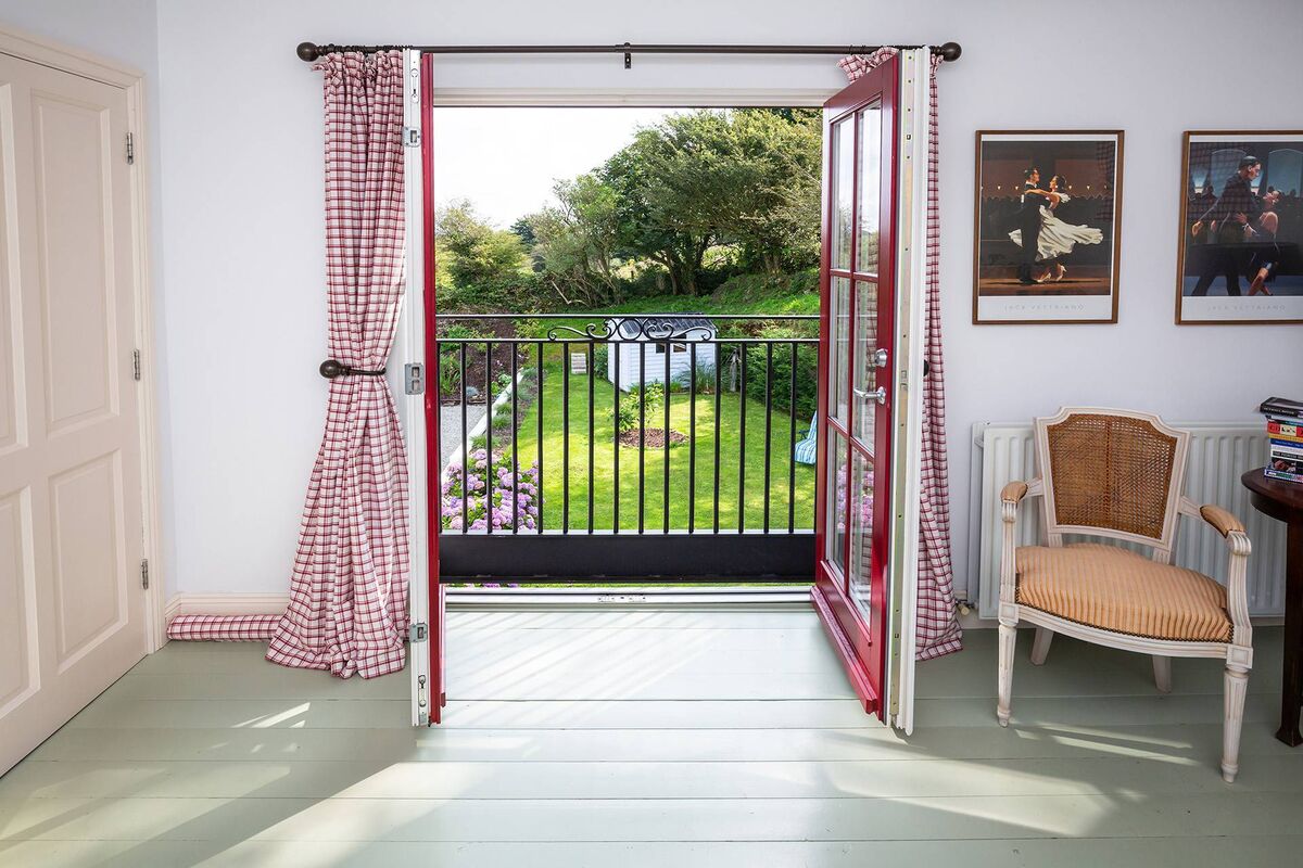 French doors in main bedroom overlook back garden