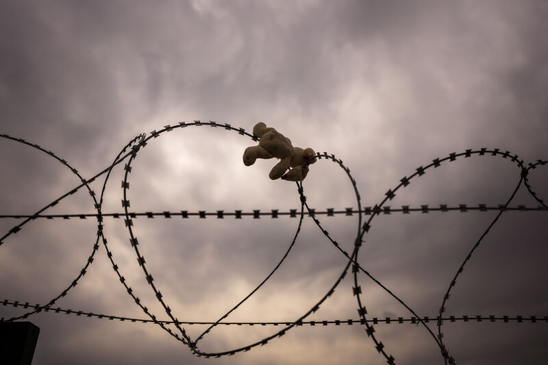 A cuddly toy doll is seen hooked on a barber wire separating Ukraine and Poland at the Medyka border crossing in Poland. Picture: AP Photo/Emilio Morenatti