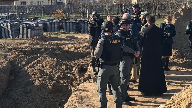 Minister for Foreign Affairs Simon Coveney (centre) being shown the site of mass graves where more than 50 bodies were found in Bucha. Picture: Department of Foreign Affairs/PA Wire