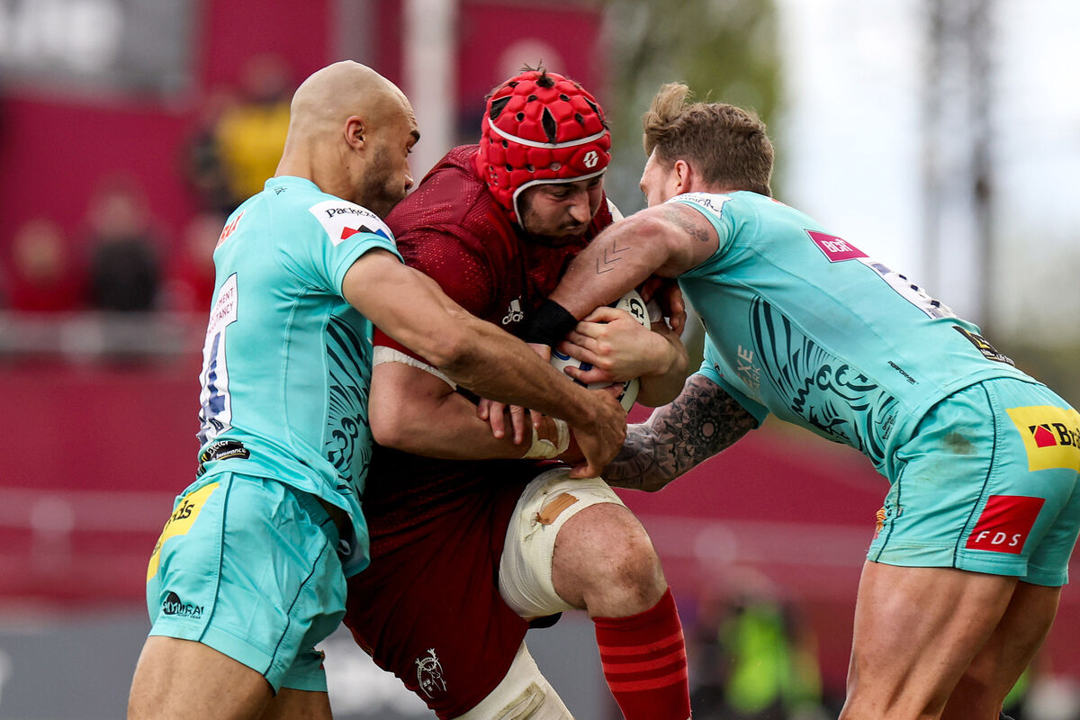PRESSURE: Munster's John Hodnett is tackled by Olly Woodburn and Stuart Hogg.