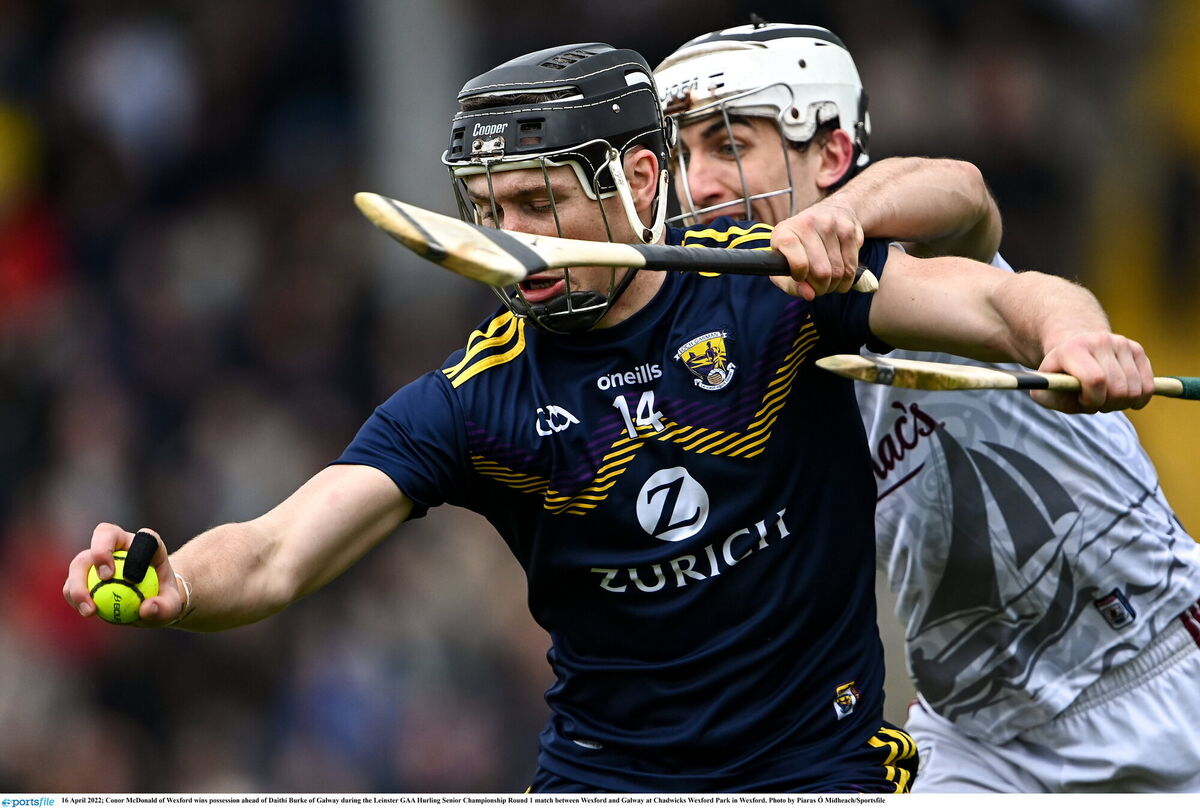 Wexford's Conor McDonald wins possession ahead of Daithí Burke of Galway
