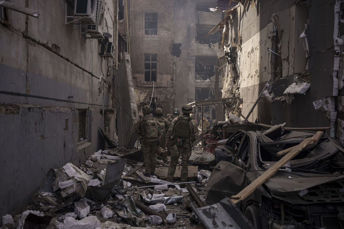 Ukrainian servicemen walk among debris of damaged buildings after a Russian attack in Kharkiv. Picture: AP Photo/Felipe Dana