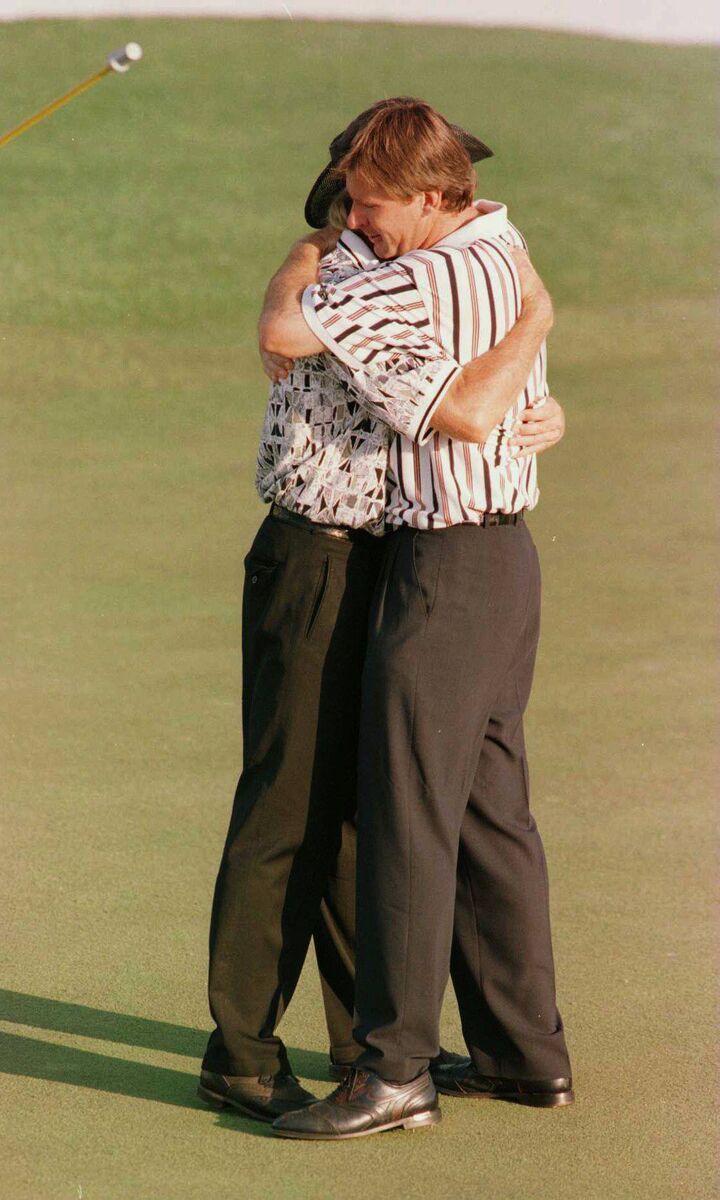 Nick Faldo consoles Norman on the 18th green
