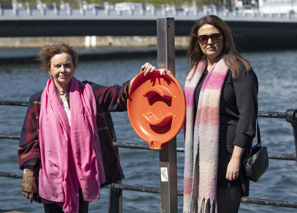 Mary Cullen, mother, and Aoife McKeone, cousin, of Daniel Cullen at the empty llfebuoy stand on Sir John Rogerson's Quay, which is still empty almost a year after Daniel Cullen lost his life after falling into the Liffey. Picture Colin Keegan/ Collins Dublin