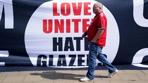 <p>Time to go: A Manchester United fan walks past a Love United Hate Glazer banner protesting the club ownership before last weekend's match at Old Trafford against Norwich City. Photo: Jacob King/PA Wire.</p>