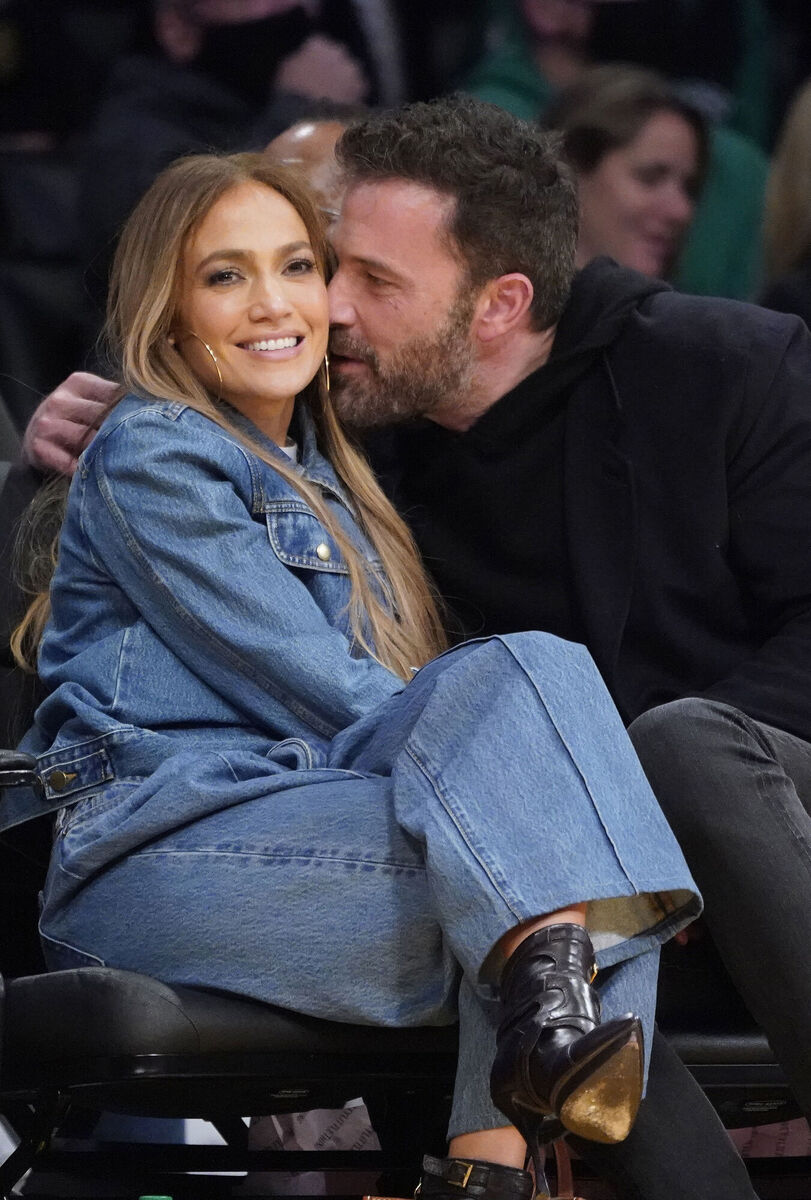 Jennifer Lopez, left, and Ben Affleck attend an NBA basketball game between the Los Angeles Lakers and the Boston Celtics on Tuesday, Dec. 7, 2021, in Los Angeles. (AP Photo/Marcio Jose Sanchez)