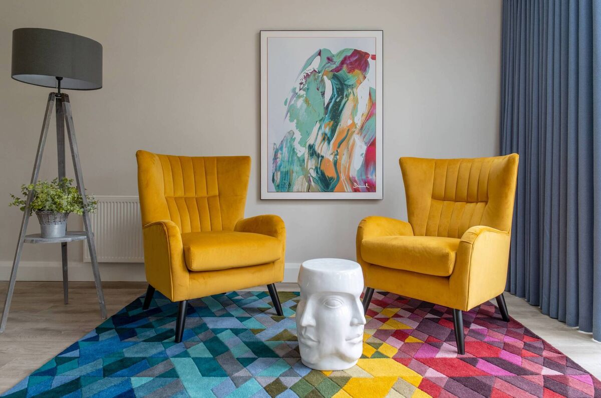 The apricot yellow armchairs in the kitchen reading area are from Michael Murphy. 