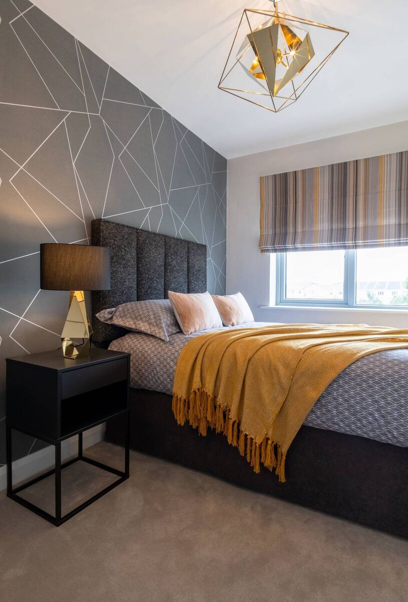 The geometric wallpaper in the boys' bedroom is from the Harlequin range. 