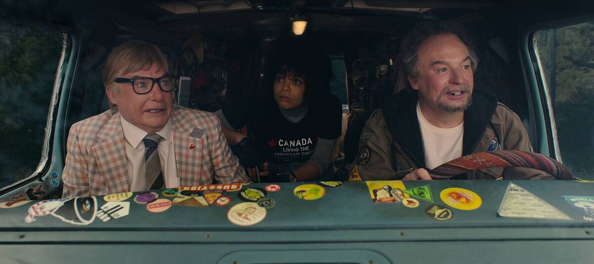 (L to R) Mike Myers as Ken Scarborough, Lydia West as Reilly Clayton, Mike Meyers as Anthony Landsdowne in The Pentaverate