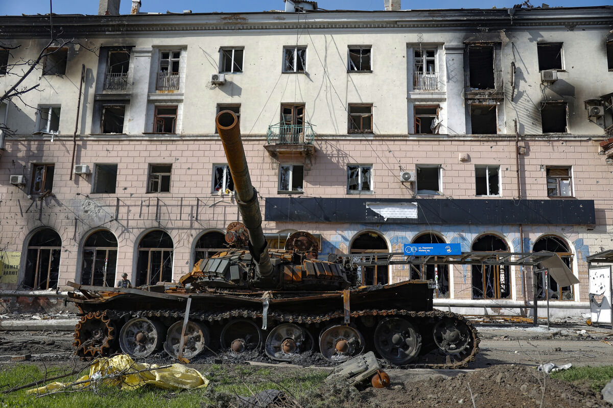 A destroyed tank and a damaged apartment building from heavy fighting are seen in an area controlled by Russian-backed separatist forces in Mariupol, Ukraine, Tuesday, April 26, 2022. (AP Photo/Alexei Alexandrov)