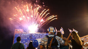 Israelis watch a fireworks display in Tel Aviv in 2018 (Oded Balilty/AP)