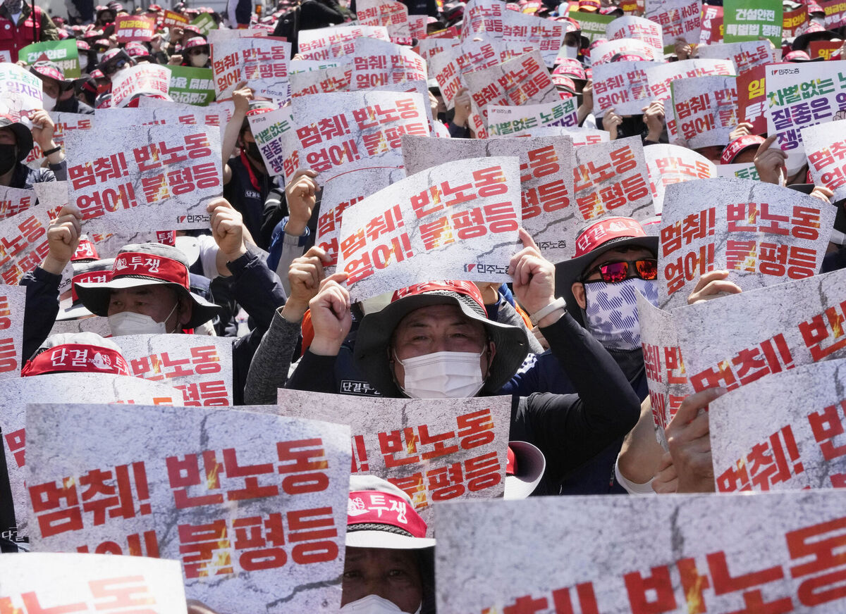 Members of the Korean Confederation of Trade Unions hold up their cards during a May Day rally demanding better working conditions and better labour rights in Seoul, South Korea, on Sunday, May 1. The signs on cards read "Stop! anti-labor policy". Picture: Ahn Young-joon/AP Members of the Korean Confederation of Trade Unions hold up their cards during a May Day rally demanding better working conditions and better labour rights in Seoul, South Korea, on Sunday, May 1. The signs on cards read "Stop! anti-labor policy". Picture: Ahn Young-joon/AP